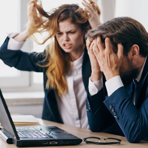 Two people frustrated in front of a computer